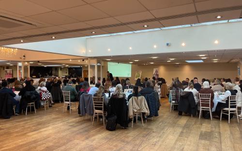 Staff and partner organisations listening to a speech at the Families First Conference