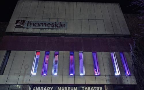 Thameside Complex lit up in white and purple for IWD 2025