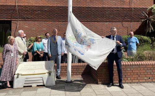 (Right) Cllr Richard Bingley, Leader of Thurrock Council, holding the Arms of the Borough of Thurrock flag
