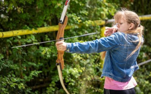 young female child holding a bow and arrow 