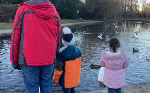 An adoptive parent, with their children