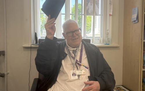Volunteer Chris raises his hat