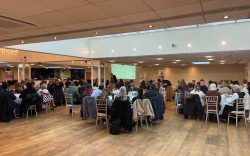 Staff and partner organisations listening to a speech at the Families First Conference