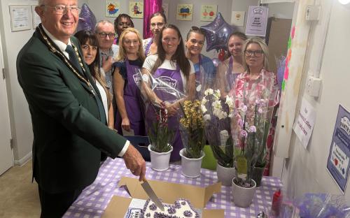 Deputy Mayor cuts birthday cake at Pantry party